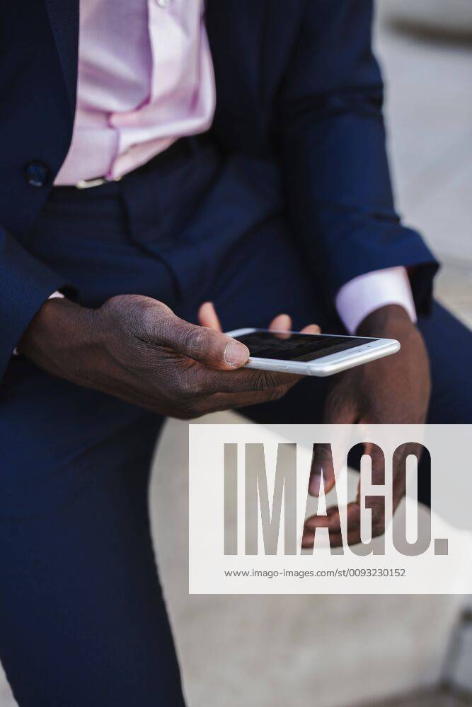 Close up of a young businessman using his smartphone model released Symbolfoto LJF00469