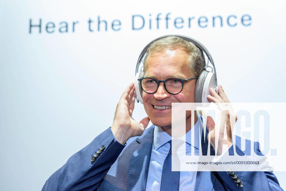 Berlins Governing Mayor Michael Müller SPD with headphones at Sennheisers stand during the opening tour of the IFA International Consumer Electronics Fair at the Berlin Exhibition Grounds snapshot photography F Boillot