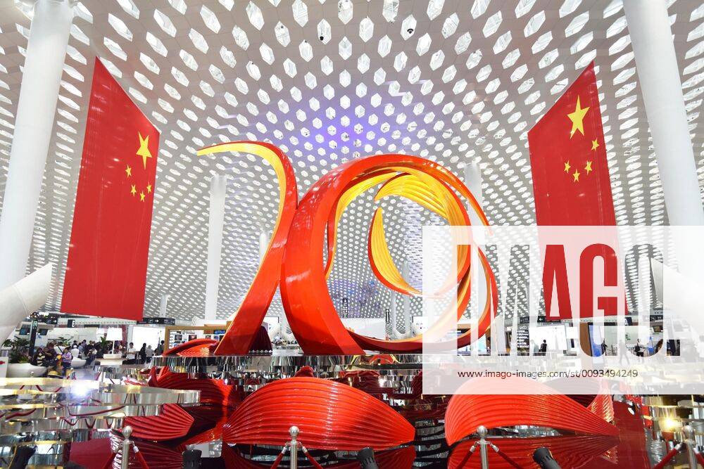 Employees holding Chinese national flags sing a song during a flash mob to mark the 70th Anniversary of the Founding of the People s Republic of China at Shenzhen Airport on September 17, 2019 in Shenzhen, GuangdongProvince of China China.