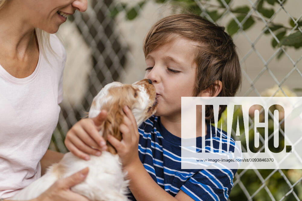 Mother snd son cuddling with cute dog puppy model released Symbolfoto property released DIGF08167