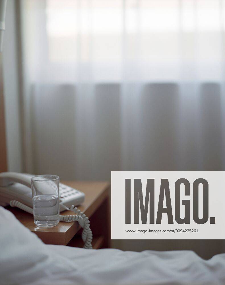 Glass of Water on Nightstand in Hotel Room,property released 03B68863