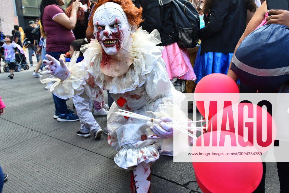 Annual Zombie Walk in Mexico City MEXICO CITY, MEXICO - OCTOBER 19: A man disguised as Pennywise (IT) is seen taking part during the march of annual Zombie Walk at Monumento of Revolucion on October 19, 2019 in Mexico City, Mexico