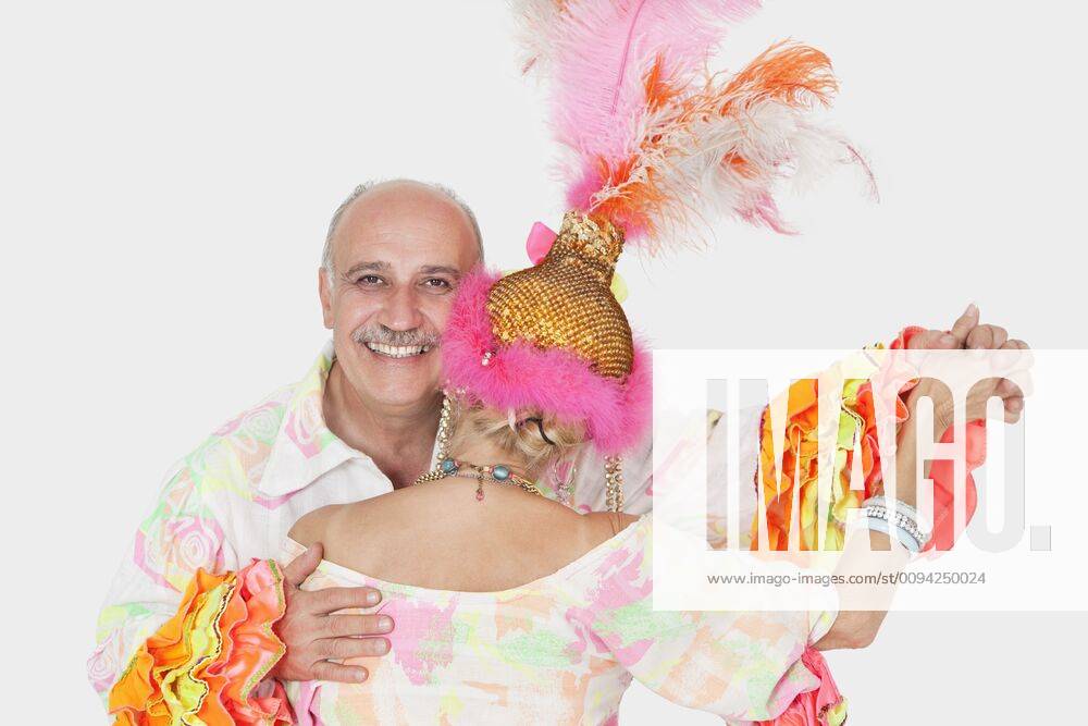 Portrait of senior couple in Brazilian outfits dancing over gray background,model released, Symbolfoto 03B94786