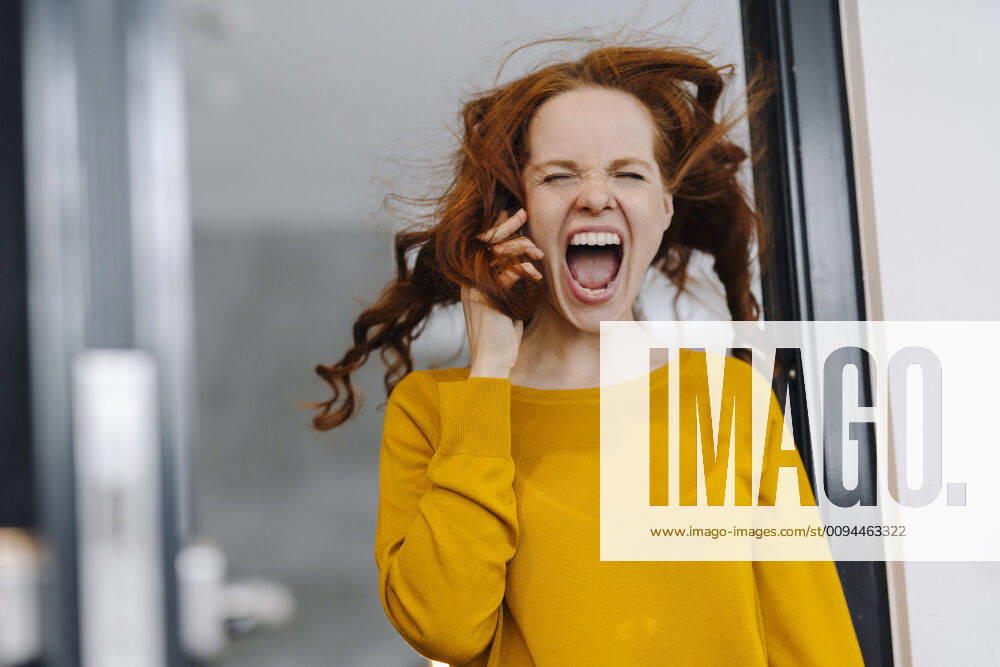 Screaming woman with windswept hair in office model released Symbolfoto property released KNSF06607