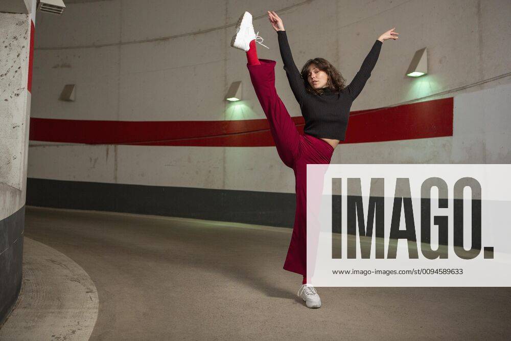 Portrait confident young woman dancing in tunnel Germany Berlin