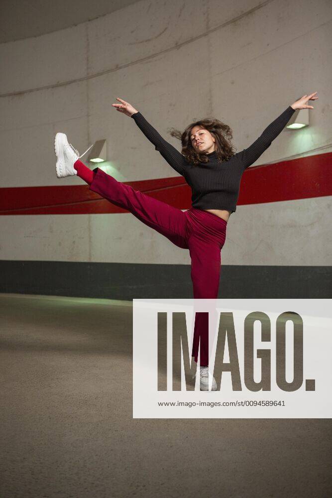 Portrait confident young woman dancing in tunnel Germany Berlin