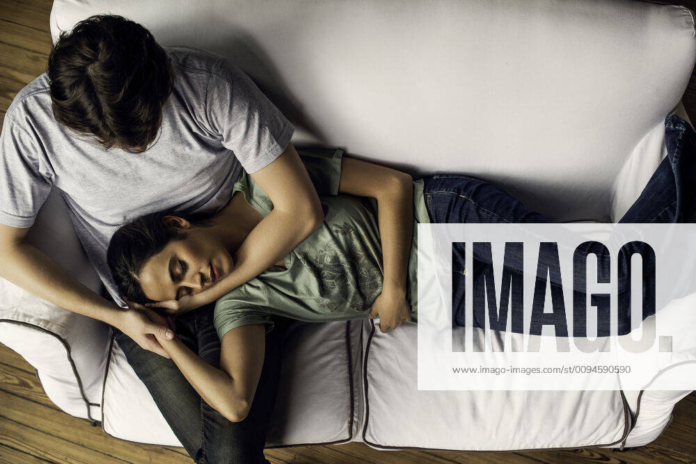 Woman napping, resting head on husband s lap