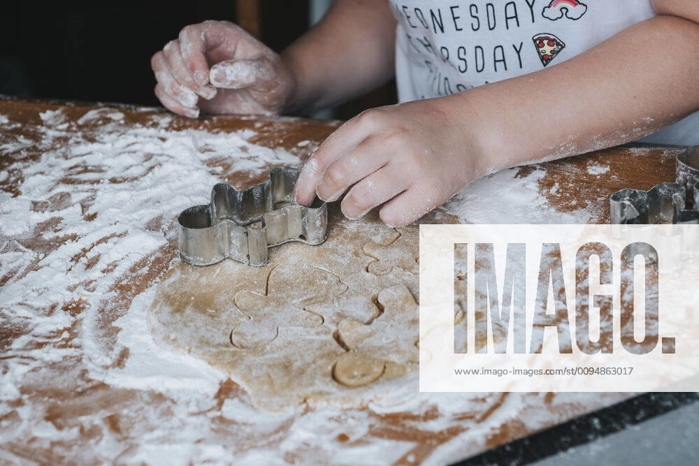 Close up of young girl cutting out gingerbread man from dough New Zealand, Taranaki, Hawera CR_LVBS191016-207949-01