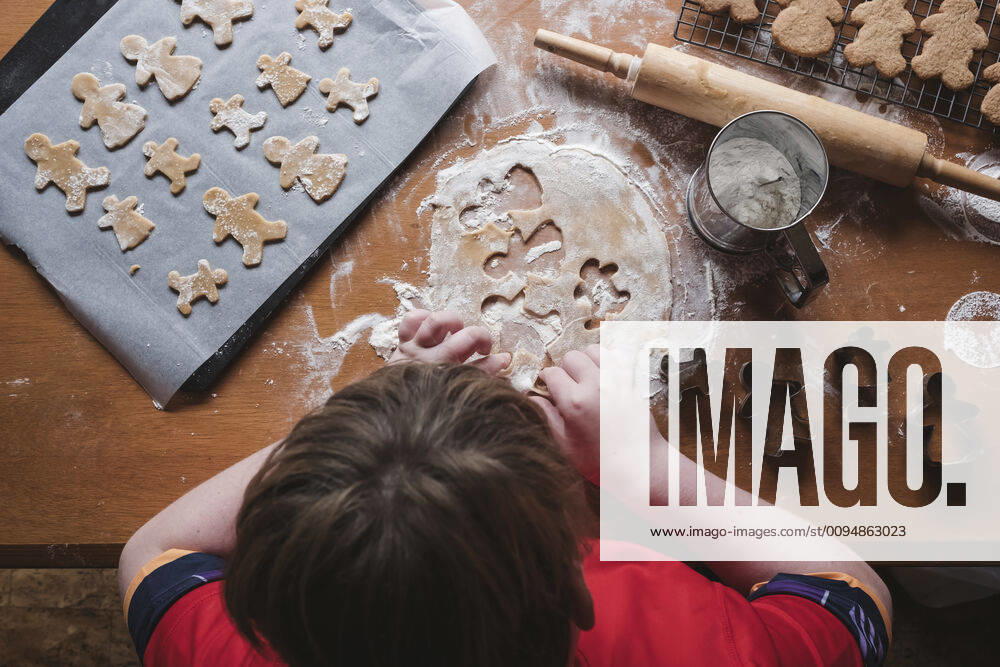 Looking down at boy cutting out gingerbread from dough New Zealand, Taranaki, Hawera CR_LVBS191016-207964-01