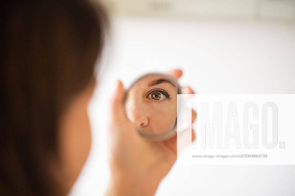 Woman Looking At Herself In The Mirror. Close up shot Russia, Smolensk Oblast, Smolensk CR_SEDO191017-224769-01