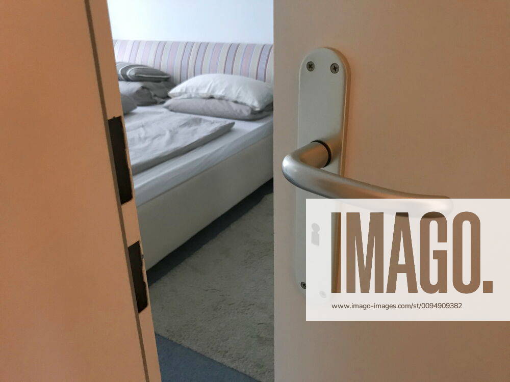 View through a crack in a door into a bedroom 07 11 2019