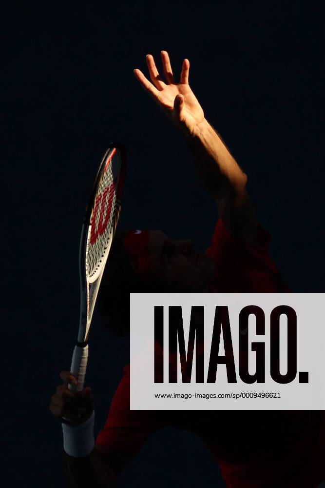 Typical: hand and racquet (of Roger Federer) through the shadowed court at RLA of 2012 Tennis Australian Open in Melbourne, 24 01 2012 -