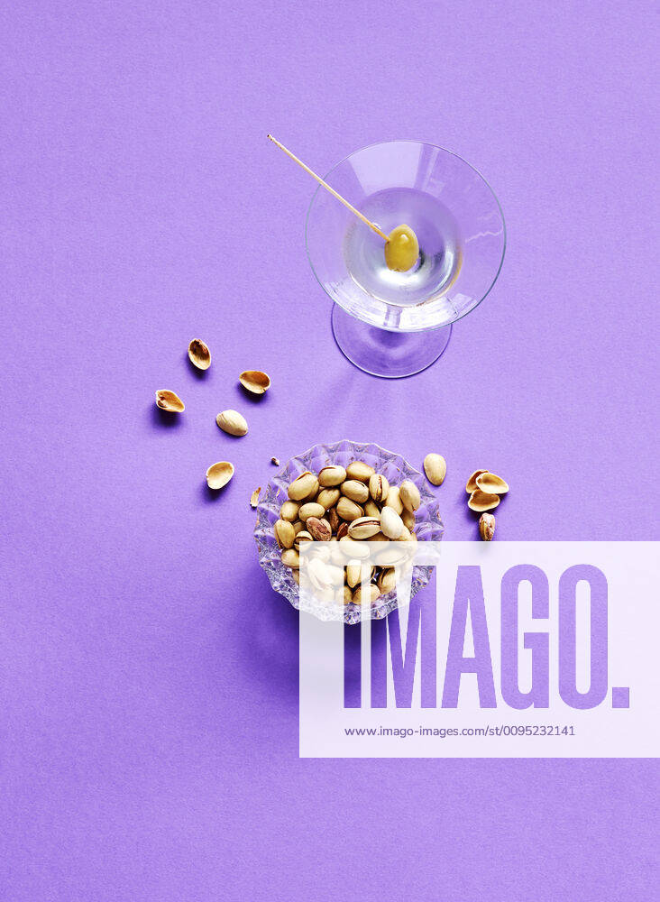 Directly above shot of pistachios and martini glass on purple background KSWF02074