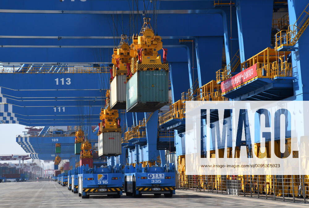 (191128) -- QINGDAO, Nov. 28, 2019 -- Vehicles wait for the loading of containers at the second phase of the automatic dock of the Qingdao port in Qingdao, east China s Shandong Province, Nov. 28, 2019. The second phase of the automatic dock of the Qingdao port was put into operation on Thursday, which applies several technological inventions developed by the Qingdao port. ) CHINA-SHANDONG-QINGDAO PORT-AUTOMATIC DOCK (CN) LixZiheng