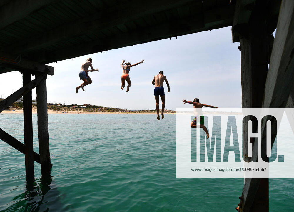 ADELAIDE HOT WEATHER, Swimmers jump from the Port Noarlunga Jetty in Adelaide, Tuesday, December 17, 2019. A heatwave spreading across Australia is expected to see parts of the nation swelter through temperatures close to 50C. ( NO ARCHIVING, , NO USE IN BOOKS WITHOUT CONSENT ADELAIDE SA AUSTRALIA