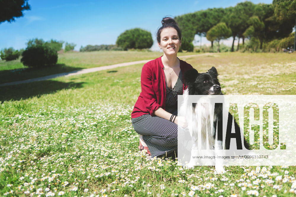 Beautiful woman with dog in a park while looking camera Barcelona, Spain CR_RAFE191116A-241304-01