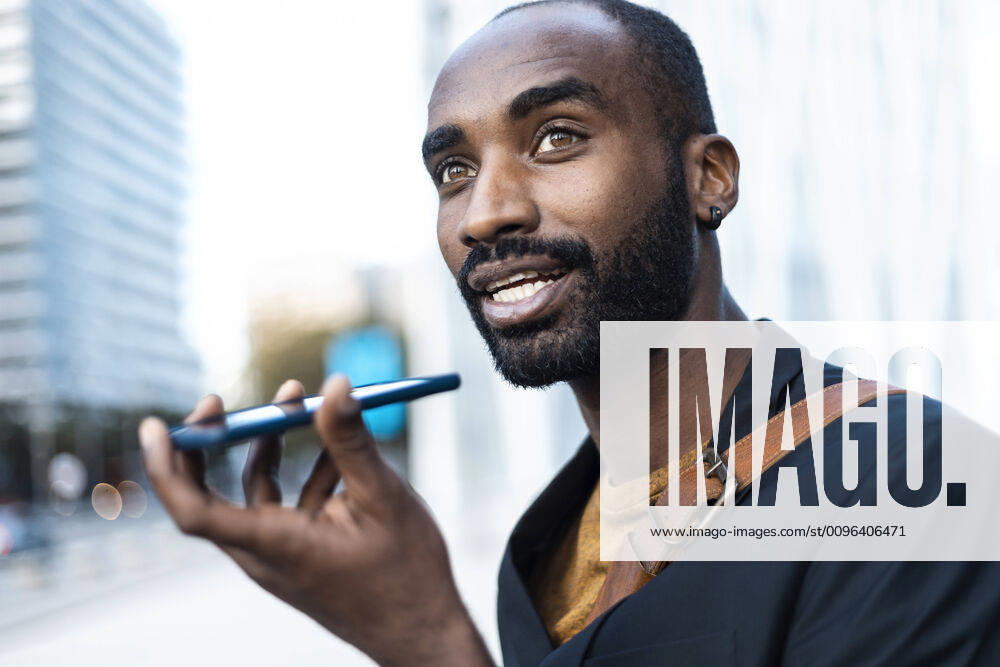 Portrait of young businessman using cell phone outdoors model released Symbolfoto JSRF00697