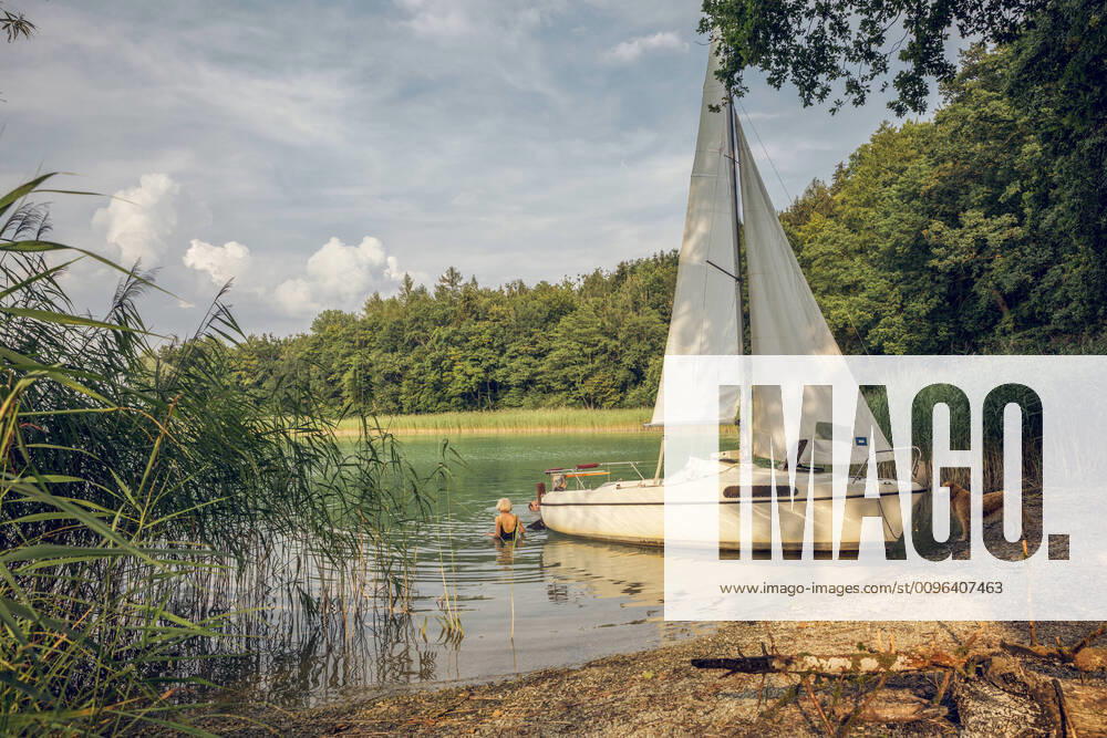 Sailing boat at lakeside, dog and two people swimming model released Symbolfoto property released MAMF01031