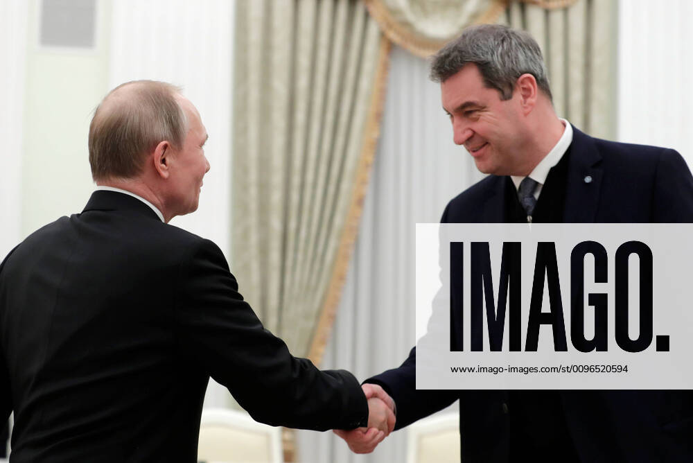 Russia s President Vladimir Putin (L) and Minister President of Bavaria Markus Soeder shake hands during a meeting at the Moscow Kremlin. Alexei Druzhinin Russian Presidential Press and Information Office TASS TS0CC243