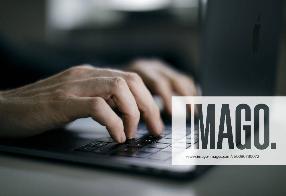 Symbol photo A man typing with his hands on a keyboard Mac in Berlin 04 02 2020 Berlin Germany
