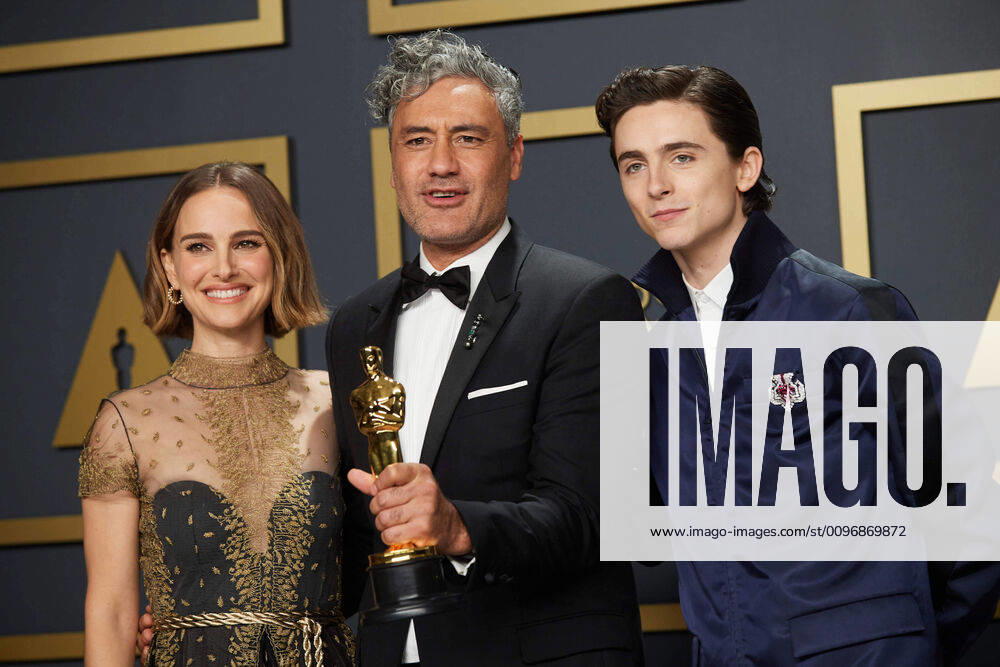 Taika Waititi poses with the Oscar for Adapted Screenplay with Natalie Portman and Timothee Chalamet during the live ABC Telecast of The 92nd Oscars at the Dolby Theatre in Hollywood, CA on Sunday, February 9, 2020. Los Angeles CA USA
