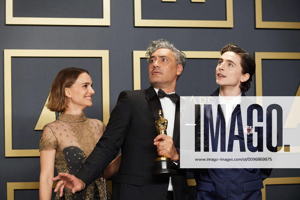 Taika Waititi poses with the Oscar for Adapted Screenplay with Natalie Portman and Timothee Chalamet during the live ABC Telecast of The 92nd Oscars at the Dolby Theatre in Hollywood, CA on Sunday, February 9, 2020. Los Angeles CA USA
