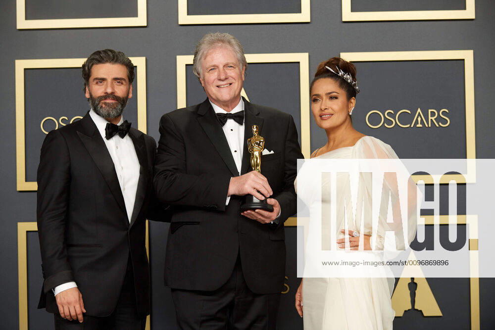 Oscar Isaac and Salma Hayek-Pinault pose with Donald Sylvester, winner of the Oscar for Sound Editing to Donald Sylvester during the live ABC Telecast of The 92nd Oscars at the Dolby Theatre in Hollywood, CA on Sunday, February 9, 2020. Los Angeles CA USA
