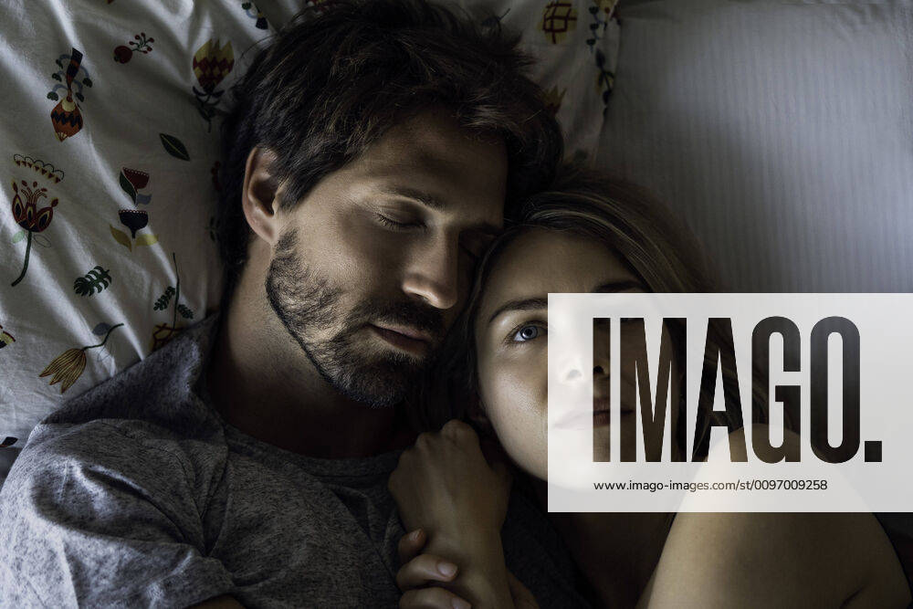Couple sleeping on bed