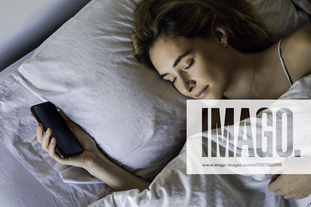 Young woman sleeping with smartphone