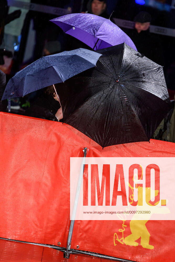 Fans under umbrellas in the rain during the premiere of the film SIBERIA at the 70th Berlin International Film Festival snapshot photography xF Boillot