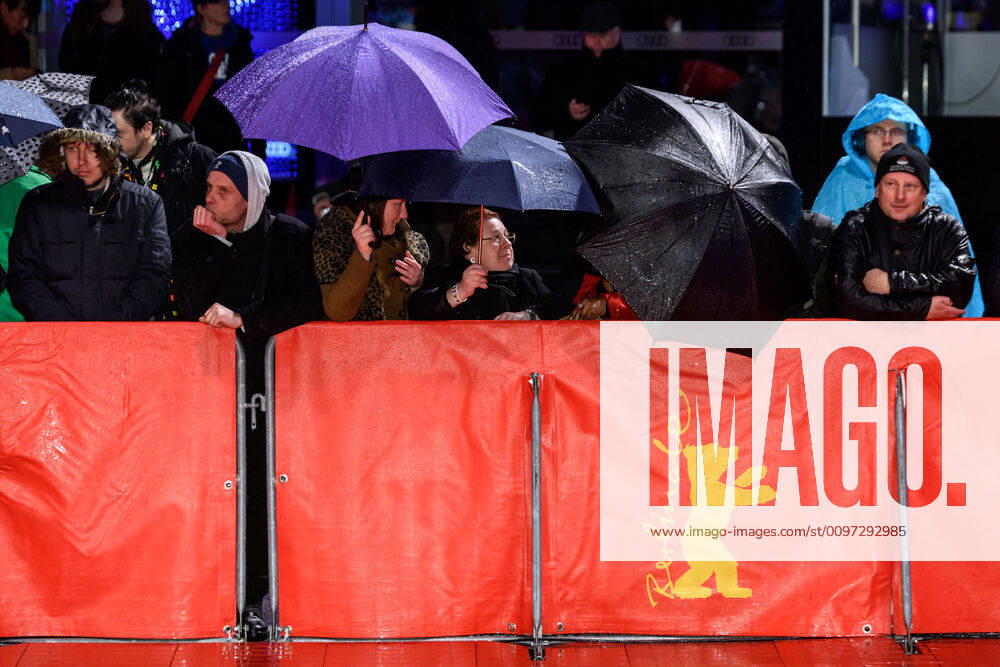 Fans under umbrellas in the rain during the premiere of the film SIBERIA at the 70th Berlin International Film Festival snapshot photography xF Boillot