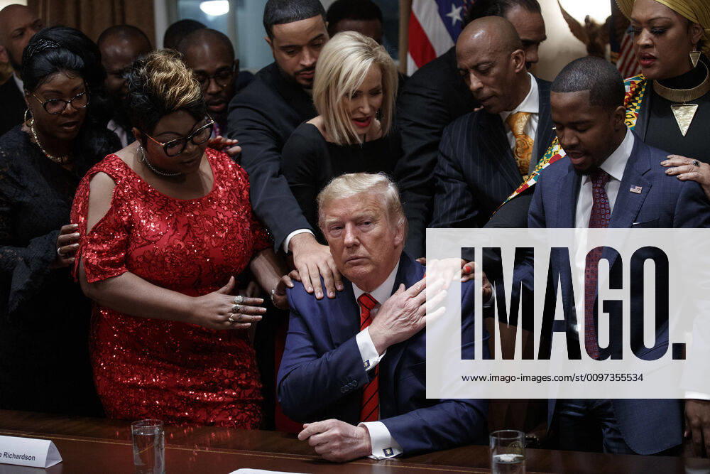 US President Donald J. Trump, with African American community, business, and faith leaders, prays in the Cabinet Room prior to the National African American History Month Reception at the White House in Washington, DC, on Thursday, February 27, 2020. WAX20200227221 SHAWNxTHEW