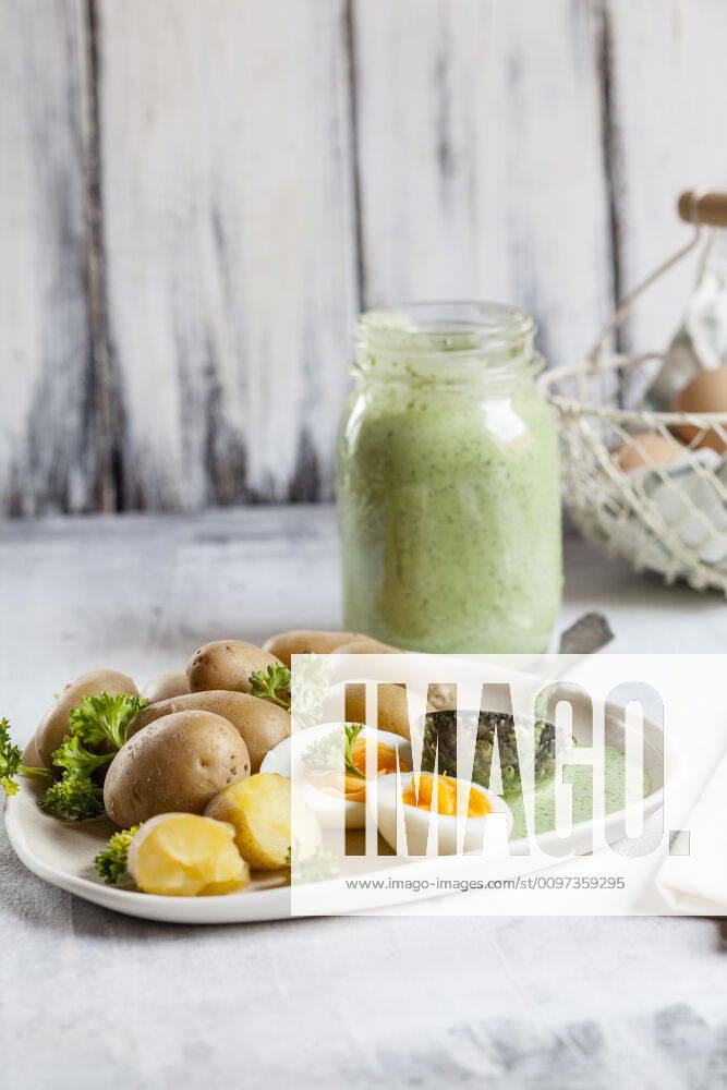 Plate of potatoes with boiled eggs, parsley and salsa verde sauce SBDF04186