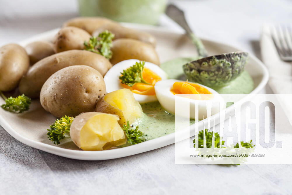 Plate of potatoes with boiled eggs, parsley and salsa verde sauce SBDF04188