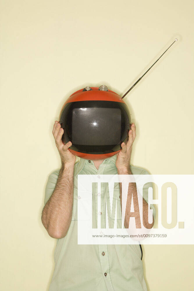 TV over man s head. Caucasian mid-adult man holding round red retro television in place of head.