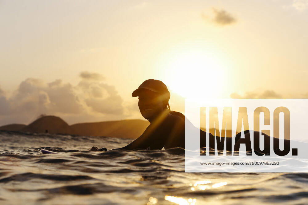 Female surfer lying on surfboard in the evening Lombok, Nusa Tenggara Bar., Indonesia ,model released, Symbolfoto CR_KOTRIN200120S-290423-01