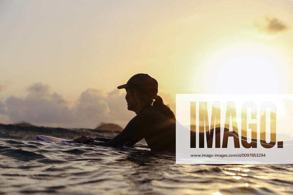 Female surfer lying on surfboard in the evening Lombok, Nusa Tenggara Bar., Indonesia ,model released, Symbolfoto CR_KOTRIN200120S-290428-01