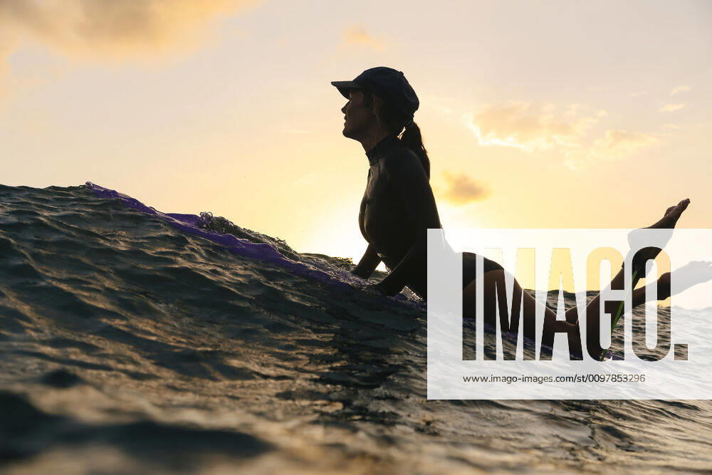 Female surfer lying on surfboard in the evening Lombok, Nusa Tenggara Bar., Indonesia ,model released, Symbolfoto CR_KOTRIN200120S-290431-01