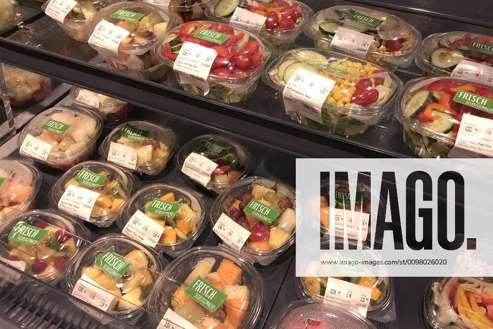 PET and PP Clamshell trays Fresh fruit in film packaging packed in a refrigerated shelf in a supermarket,Discounter REWE fruit salad,fruit bowls,salad,fresh salad
