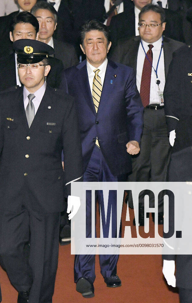Japan PM Abe Japanese Prime Minister Shinzo Abe (C) heads to a session of the House of Councillors Budget Committee in Tokyo on March 16, 2020.