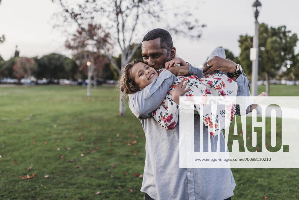 Happy father holding cute girl at park playground at dusk San Diego, CA, United States ,model released, Symbolfoto CR_KESM200224-295750-01
