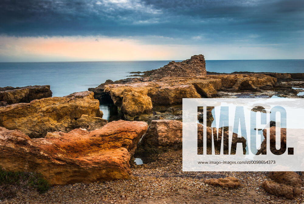 Rocky Coast with Ancient Ruins Rocky Coast with Ancient Ruins in the Mediterranean Sea in the Morning
