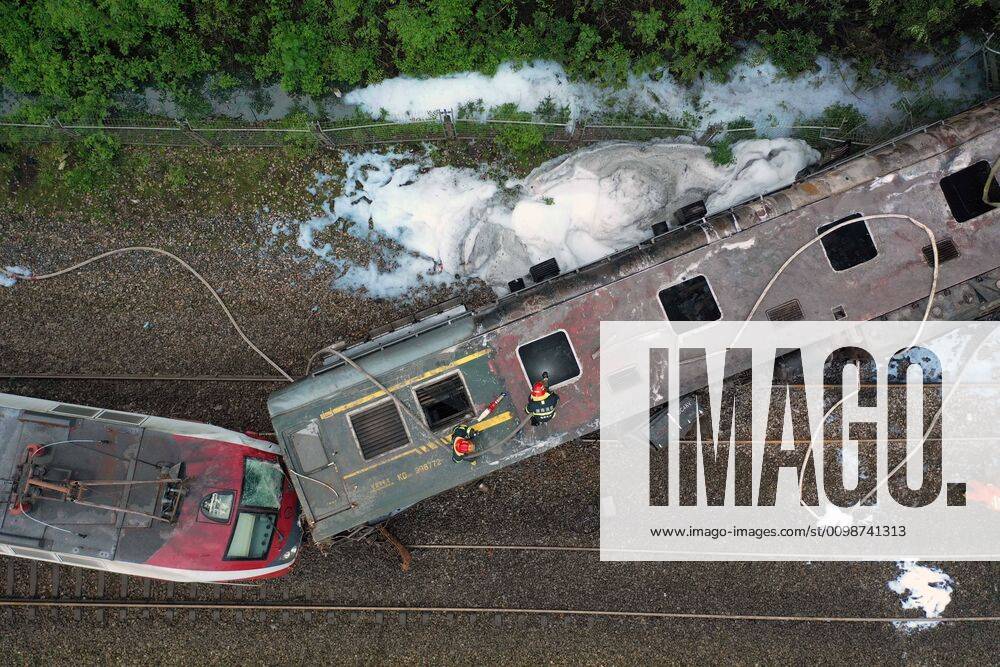 (200330) -- CHENZHOU, March 30, 2020 -- Aerial photo taken on March 30, 2020 shows firefighters working at the accident site after a train derailed at Yonghua Village of Yongxing County in Chenzhou City, central China s Hunan Province. One person was killed and 127 others injured after the train derailed in the city of Chenzhou in central China s Hunan Province Monday, local authorities said. The accident happened in Yongxing County at 11:40 a.m. when the train ran into a landslide, leaving five carriages derailed. The power generation car was caught on fire. The fire has been put out and all of the injured have been sent to hospitals, with four in serious conditions, local authorities said. The train, T179, was running from the city of Jinan, east China s Shandong Province, to Guangzhou in south China s Guangdong Province, a