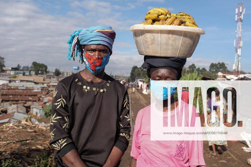 David Avido and a local business woman takes a posture together with their safety handcrafted facemasks. Nairobi Kenya - ZUMAd156 20200326_zip_d156_024