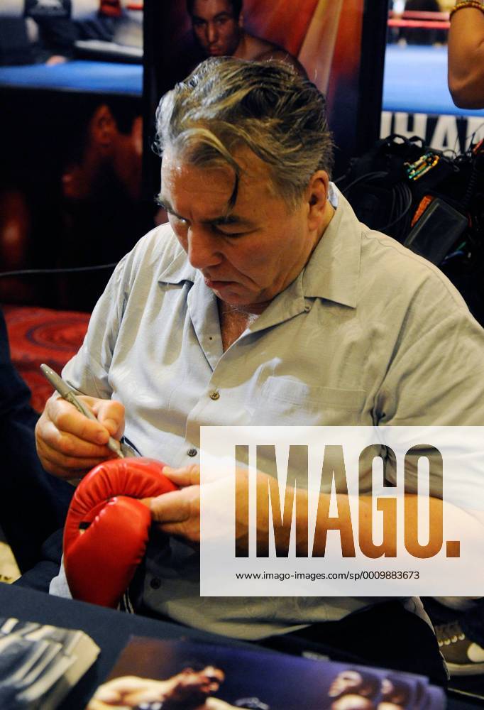 Feb. 18, 2012 - Las Vegas, Nevada, US - Retired boxer GEORGE CHUVALO signs a boxing glove during a meet and greet session at the MGM Grand Hotel on Saturday, Feb. 18, 2012 in Las Vegas, Nevada. Chuvalo along with other retired boxers greeted boxing fans at the MGM in conjunction with the Keep Memory Alive s 16th Annual Power of Love Gala honoring Muhammad Ali s 70th birthday. Boxers Sign Autographs In Las Vegas - ZUMAbk3