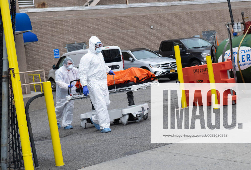 Hospital workers are seen transporting a body to a portable morgue outside of the hospital..The state of New York has over 122,000 confirmed corona virus cases and over 4,000 deaths. New York City United States - ZUMAs197 20200404_zaa_s197_203