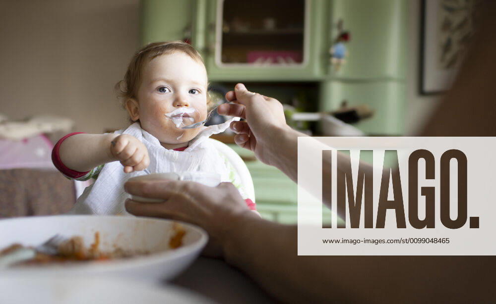 Portrait of a little boy eating, Bonn, 02 04 2020 The father feeds the boy a spoonful of yoghurt Bonn Germany