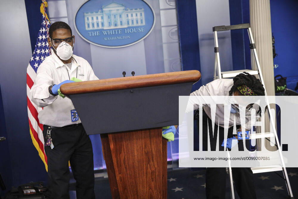 Members of the White House staff clean the podium ahead of a coronavirus task force briefing in response to the COVID-19 coronavirus pandemic in the James S. Brady Press Briefing Room at the White House on on April 9, 2020 in Washington, DC Washington USA - ZUMAs152 20200409_zaa_s152_013