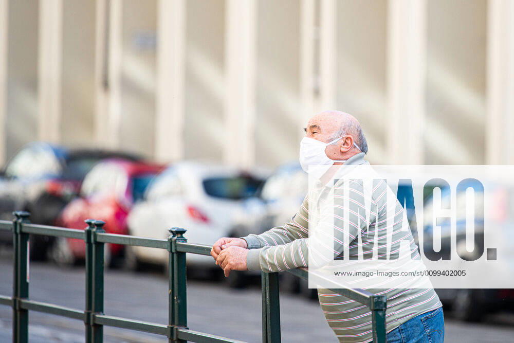 Italy: Turin lockdown 14th April 2020 People wear a safety mask in Piazza Castello in a deserted Turin on April 14, 2020 in Italy, during the country s lockdown aimed at curbing the spread of the COVID-19 infection, caused by the novel coronavirus. Turin Piedmont Turin Italy