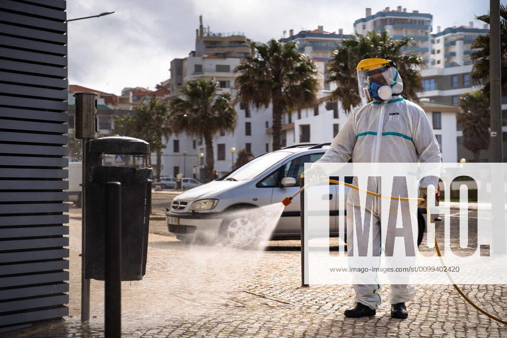 An employee of the Ericeira parish council, equipped with the recommended protective materials, disinfects the street with a solution based with hypochlorite (bleach)..The municipality of Mafra had 70 cases of COVID-19 pandemic. In order to prevent the spread of the virus, the Ericeira Parish Council perform weekly street disinfection. Ericeira Portugal - ZUMAs197 20200414_zaa_s197_169